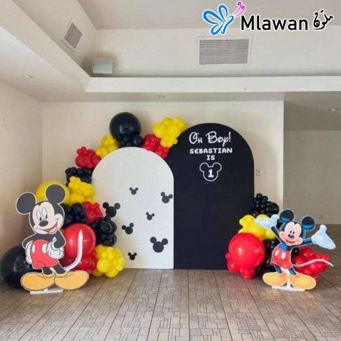 Mickey Mouse birthday party decoration setup with backdrops and balloons