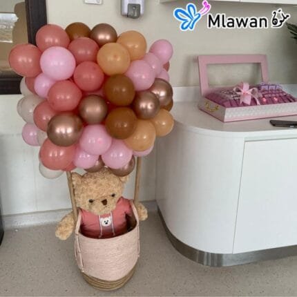 Teddy bear in hot air balloon basket for birthday gift or newborn celebration