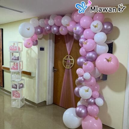 Hospital room entrance decorated with custom balloon arch and baby name sign in Ajman