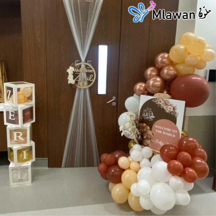 Baby-themed balloon easel and name boxes at hospital entrance